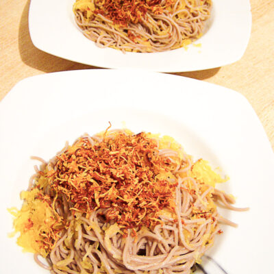 frittierter und gegarter Spaghettikürbis mit Sobanudeln auf eckigem Teller